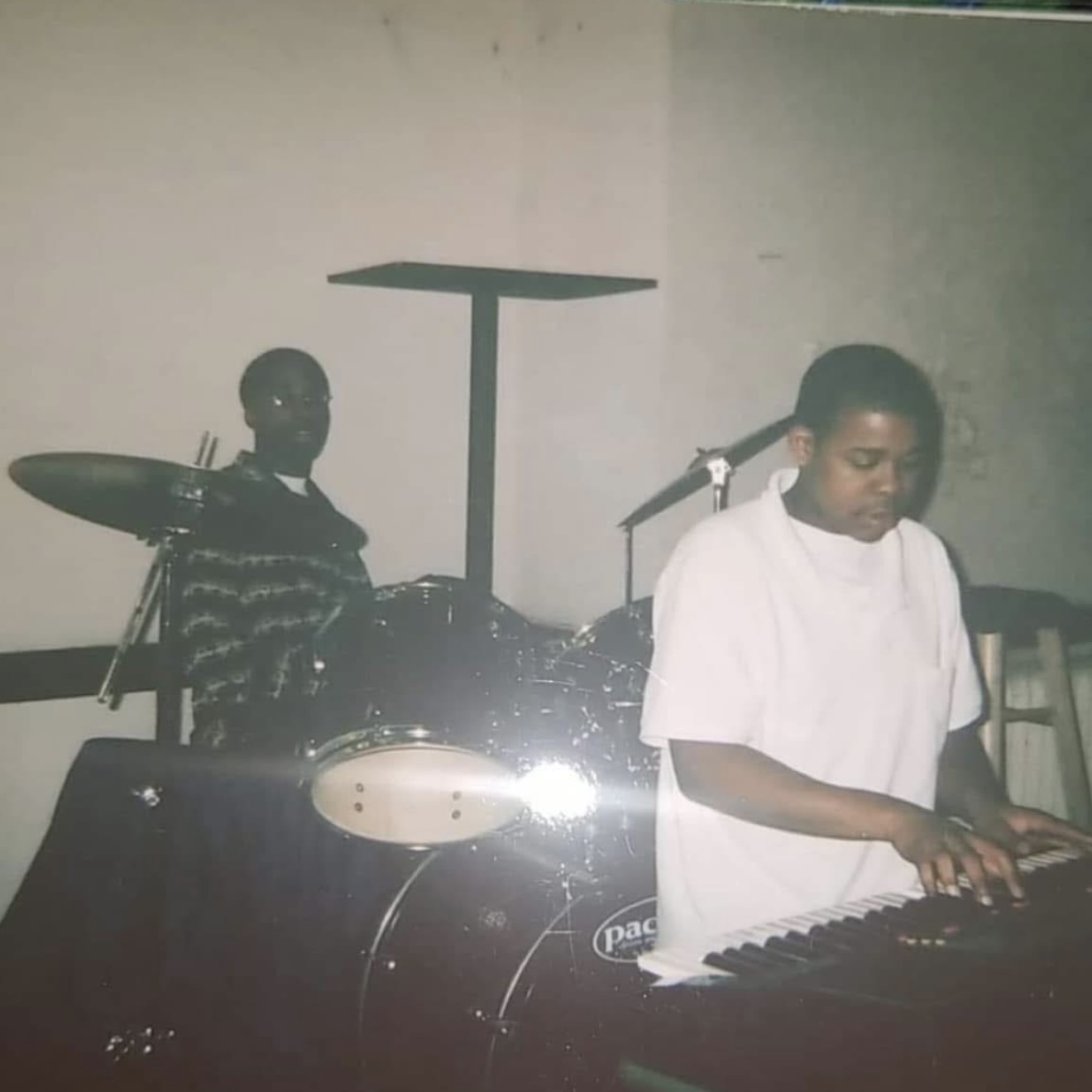 Jerome playing keyboard with a drummer behind him