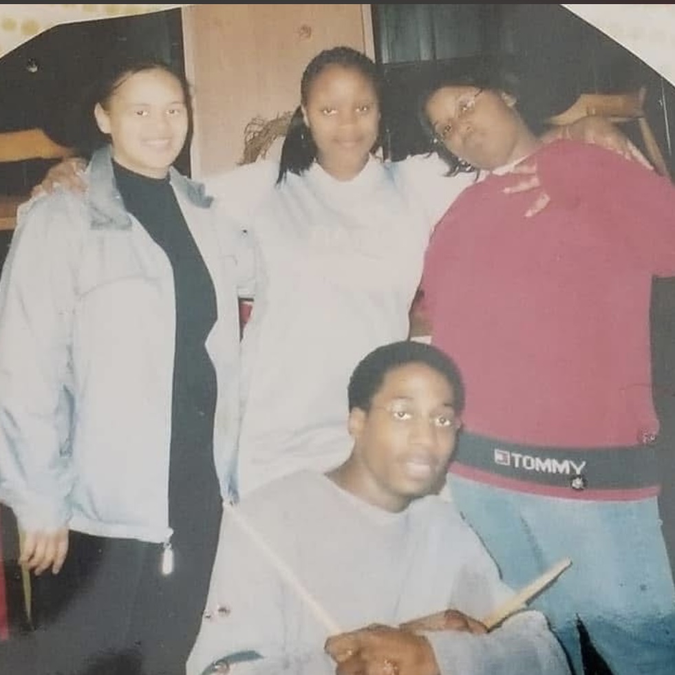 Vintage photograph of Jerome seated with three family members standing behind him