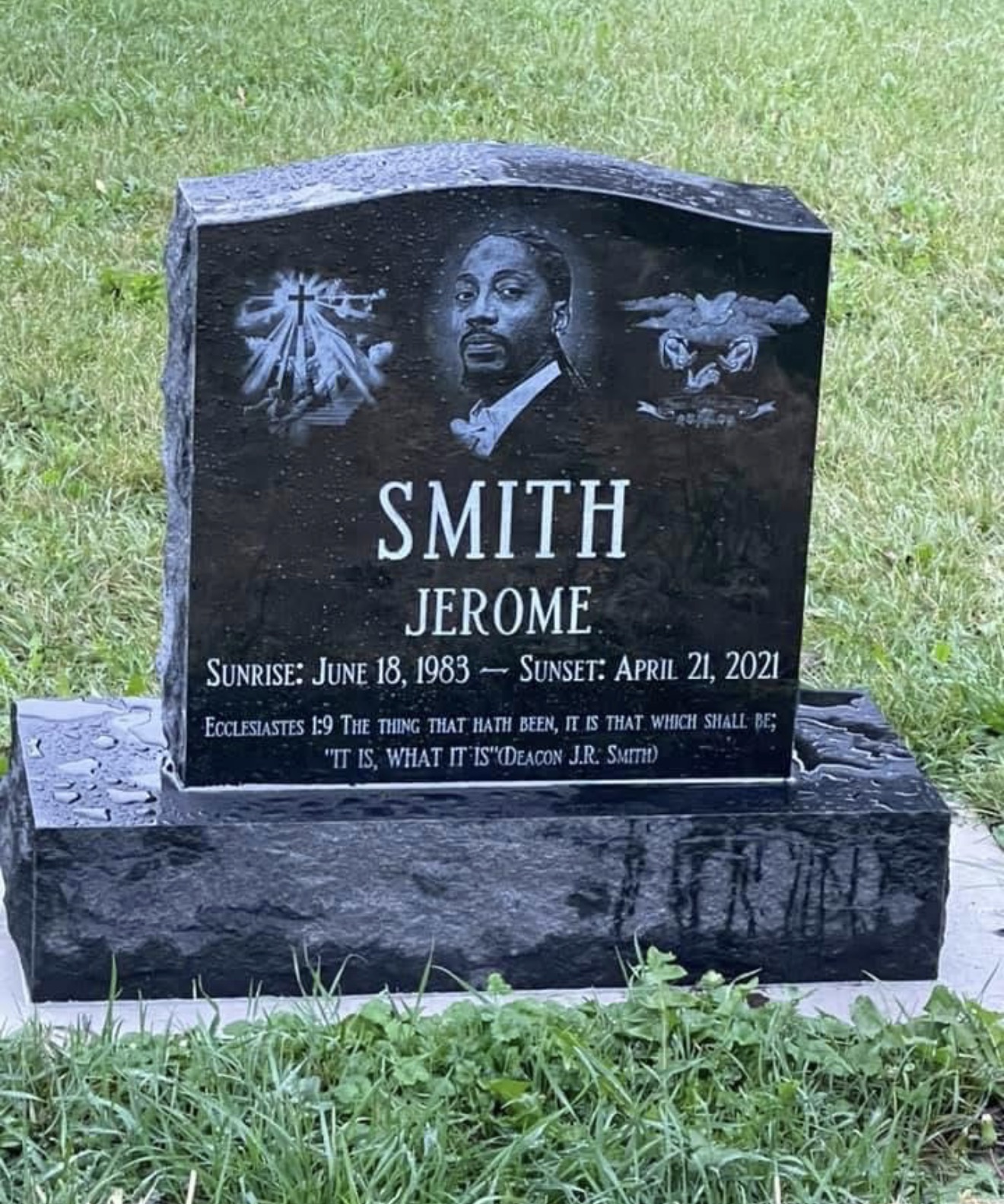 Jerome Robert Smith's black granite headstone, engraved with his portrait, a cross and a dove