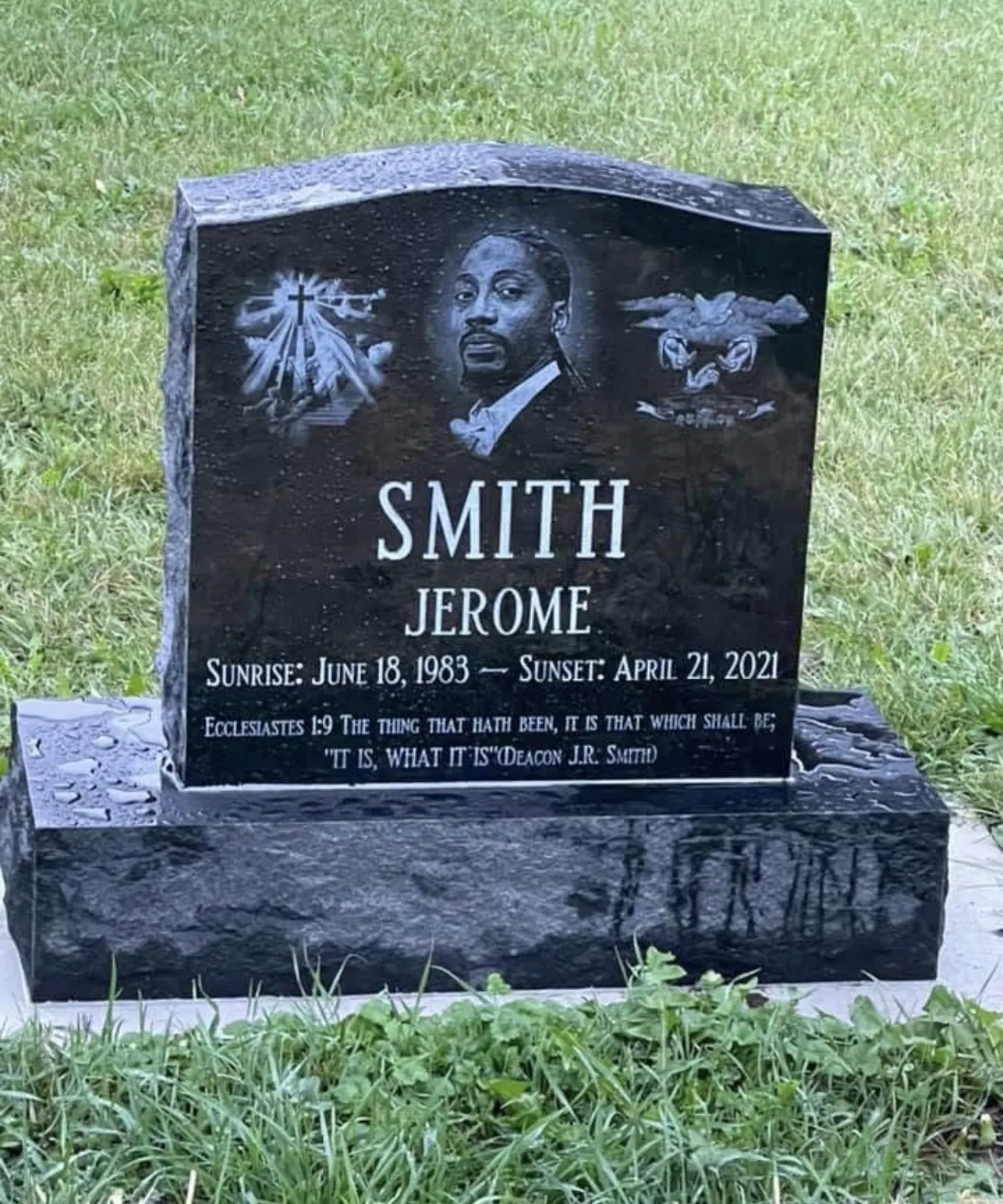 Jerome Robert Smith's black granite headstone, engraved with his portrait, a cross and a dove